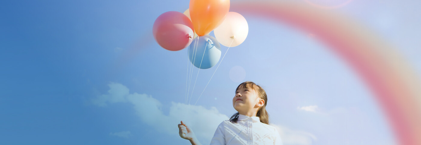 a girl is holding balloons, great eastern takaful take care your family future